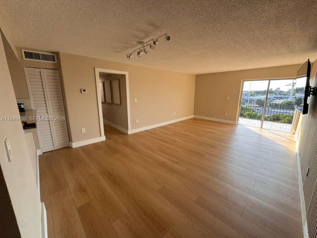 1990 West 56th Street, Unit 1311 Hialeah, FL 33012 - Photo 2 of 14 wooden floor in an empty room