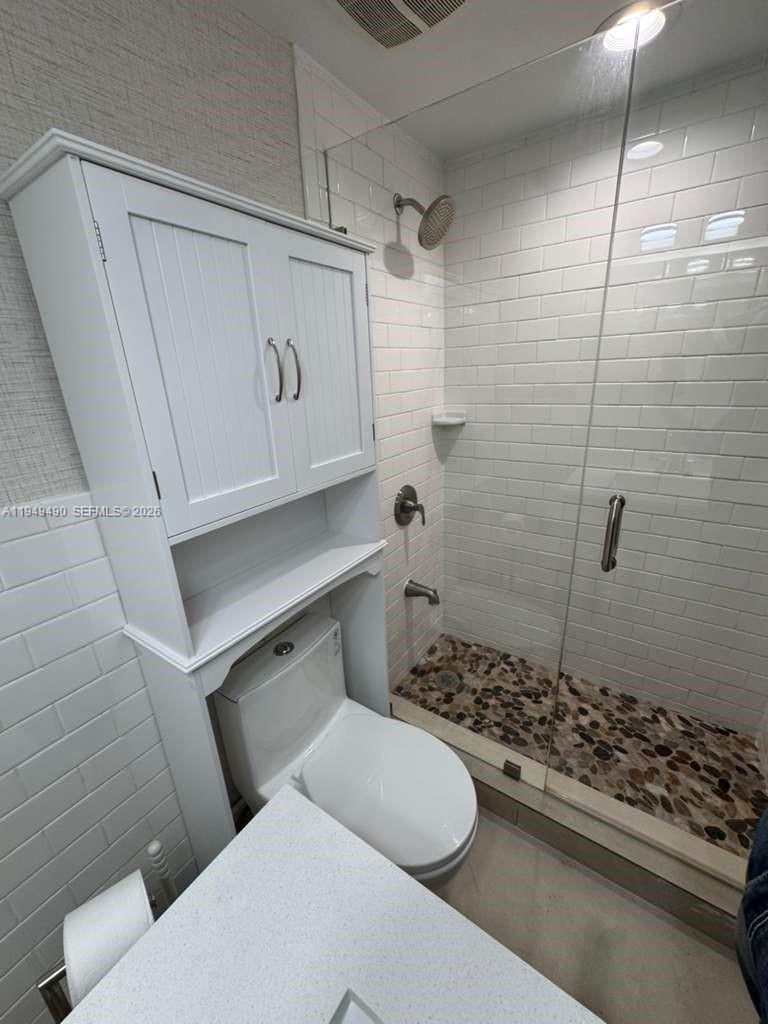1990 West 56th Street, Unit 1311 Hialeah, FL 33012 - Photo 10 of 14 a bathroom with a toilet a sink and shower
