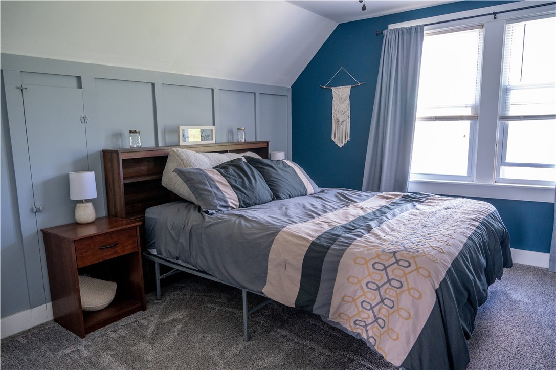 3365 Trapping Brook Road Wellsville, NY 14895 - Photo 26 of 47 The primary has space, light and board and batten, like the guest room. There is also a closet and there are knee-wall cabinets for even more storage.