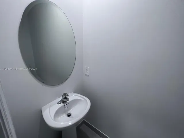 a bathroom with a sink and mirror