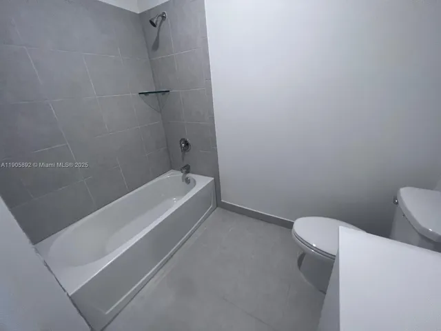 a bathroom with a toilet and a bathtub