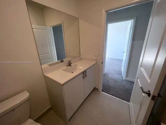 a utility room with sink dryer and washer