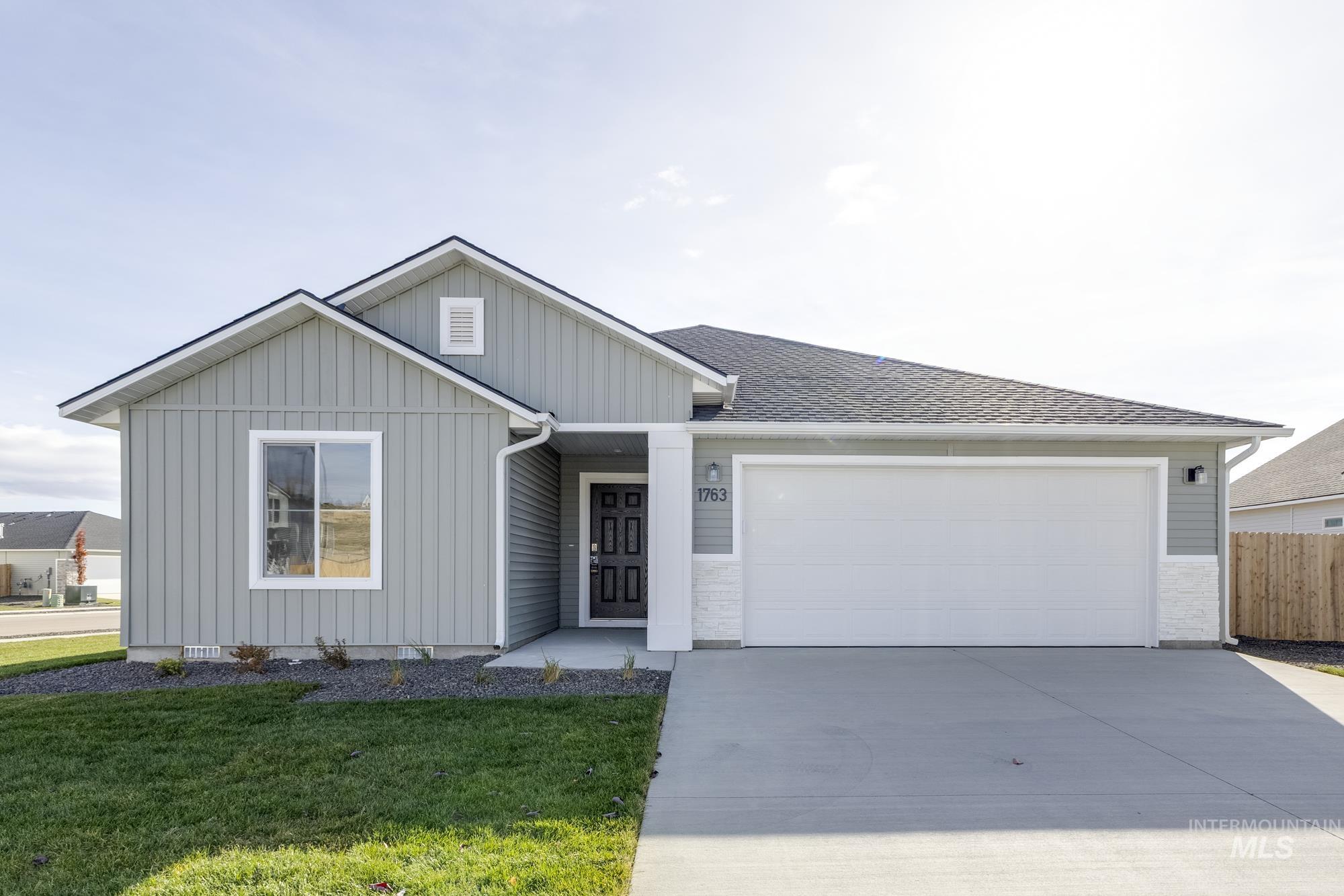 1763 Webb Brk Street Middleton, ID 83644 - Photo 1 of 1 Ranch-style home with board and batten siding, concrete driveway, a garage, and a shingled roof