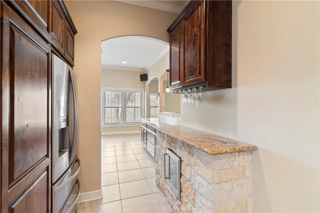 a kitchen with granite countertop a refrigerator and a sink