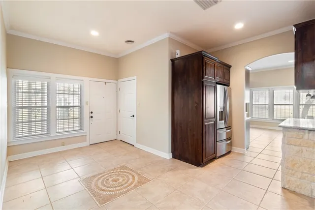 a view of an empty room with a kitchen