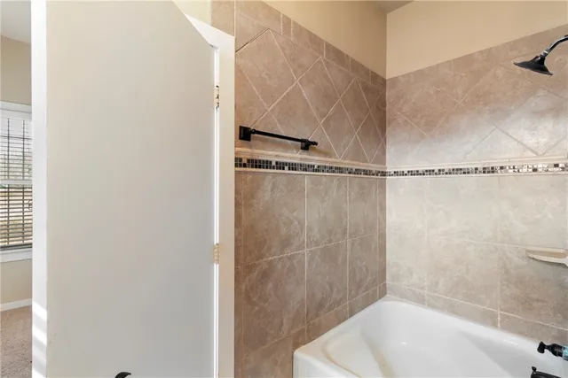 a bathroom with a shower and a bath tub