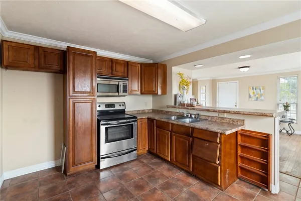 a kitchen with stainless steel appliances granite countertop a stove and a sink