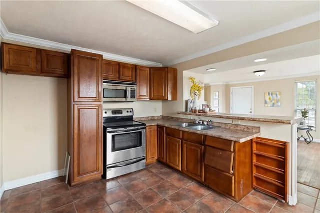 a kitchen with stainless steel appliances granite countertop a stove and a sink