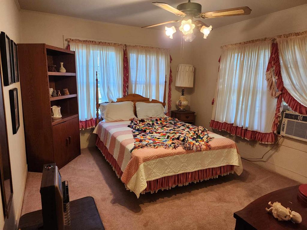 14816 Highway 84 Logansport, LA 71049 - Photo 13 of 21 a bedroom with a large bed and a chandelier
