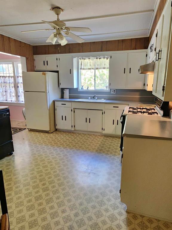14816 Highway 84 Logansport, LA 71049 - Photo 17 of 21 a kitchen with a refrigerator stove and wooden floor