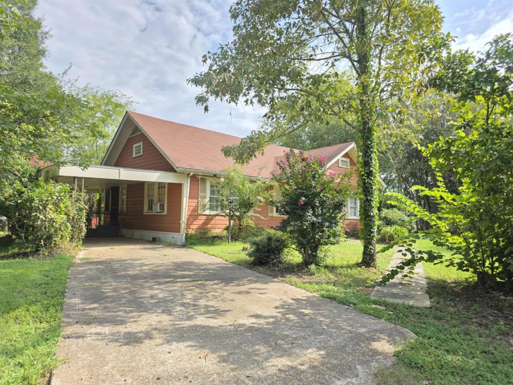 14816 Highway 84 Logansport, LA 71049 - Photo 3 of 21 a front view of a house with a garden and yard