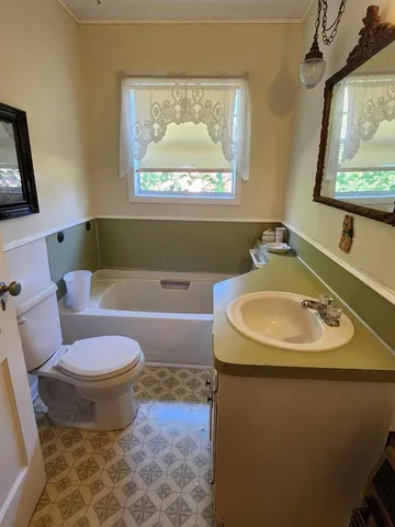 a bedroom with bed and window