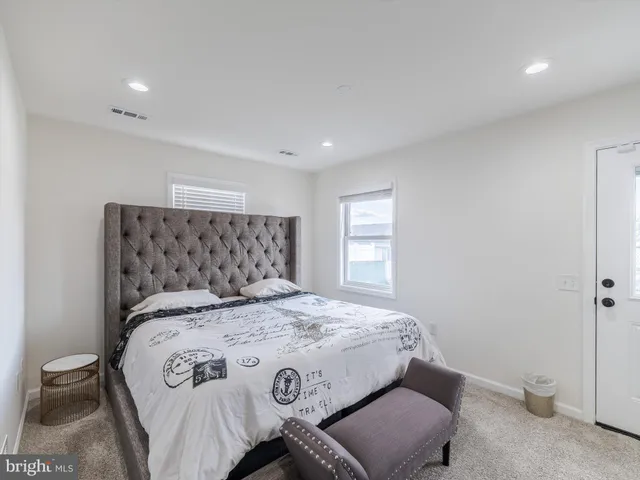 a bedroom with a bed and a chair