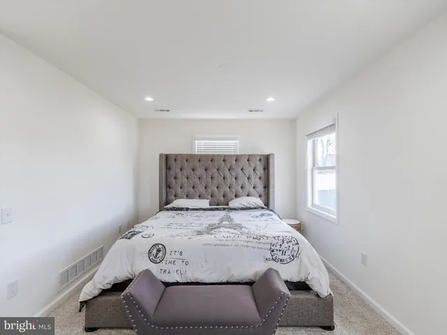 a bedroom with a large bed and a window