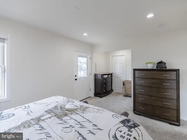 a bedroom with a bed and a mirror