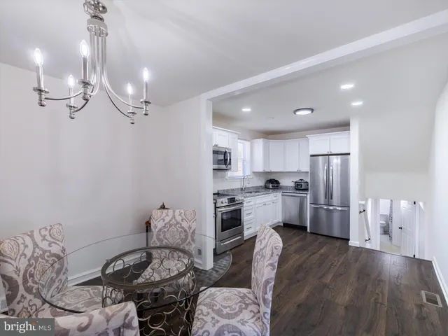 a kitchen with refrigerator cabinets and wooden floor