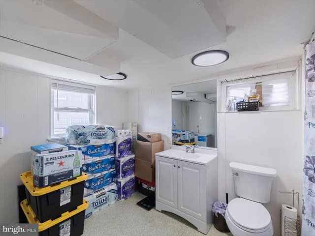 a bathroom with a sink toilet vanity and tub