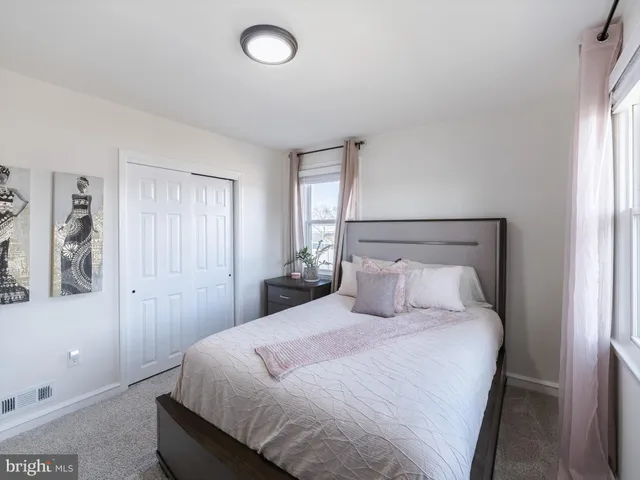 a bedroom with a large bed and a window