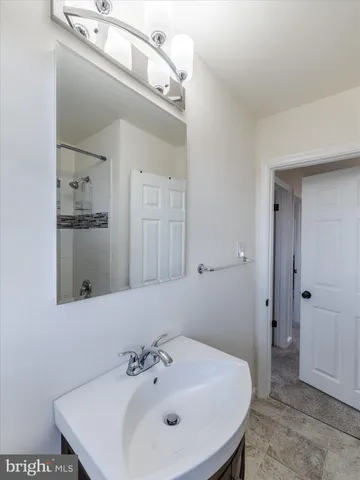 a bathroom with a sink a mirror and shower