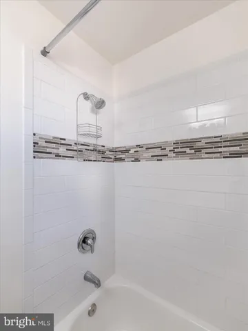 a bathroom with a tub and a shower