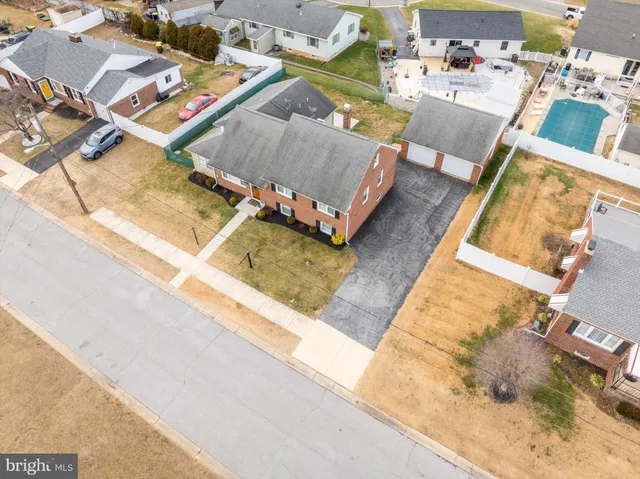 an aerial view of a house with a swimming pool