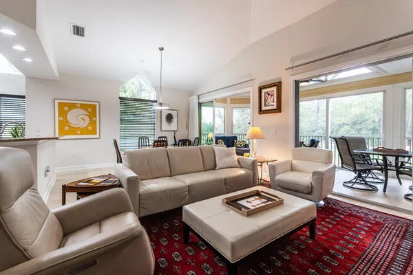 a living room with furniture a rug and a chandelier