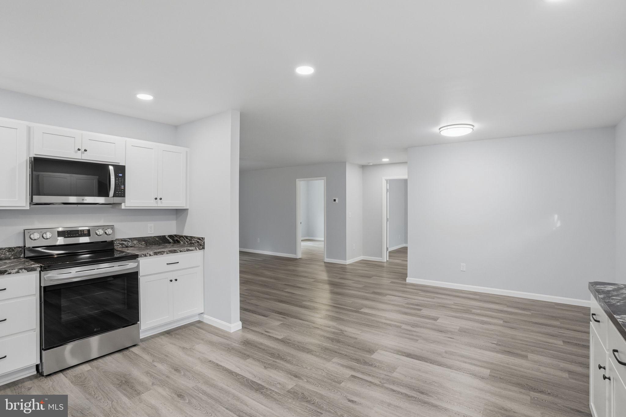 897 Horsepen Road Felton, DE 19943 - Photo 21 of 38 a view of a kitchen with a sink stove and wooden floor