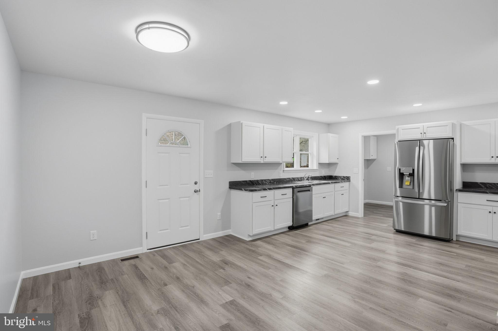 897 Horsepen Road Felton, DE 19943 - Photo 24 of 38 a kitchen with a refrigerator and a sink