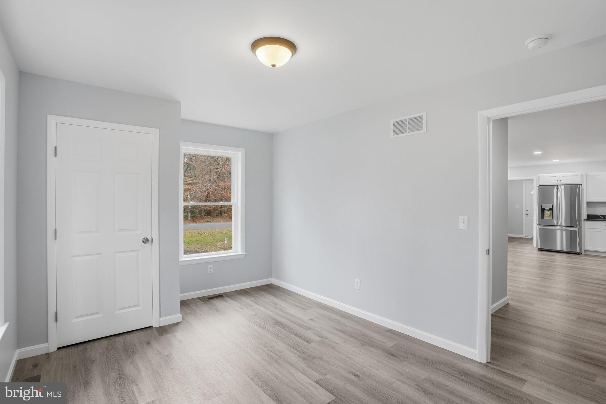 897 Horsepen Road Felton, DE 19943 - Photo 30 of 38 an empty room with wooden floor and windows