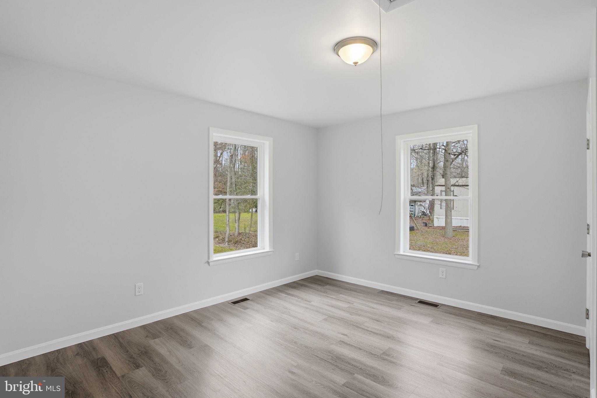 897 Horsepen Road Felton, DE 19943 - Photo 32 of 38 an empty room with wooden floor and windows