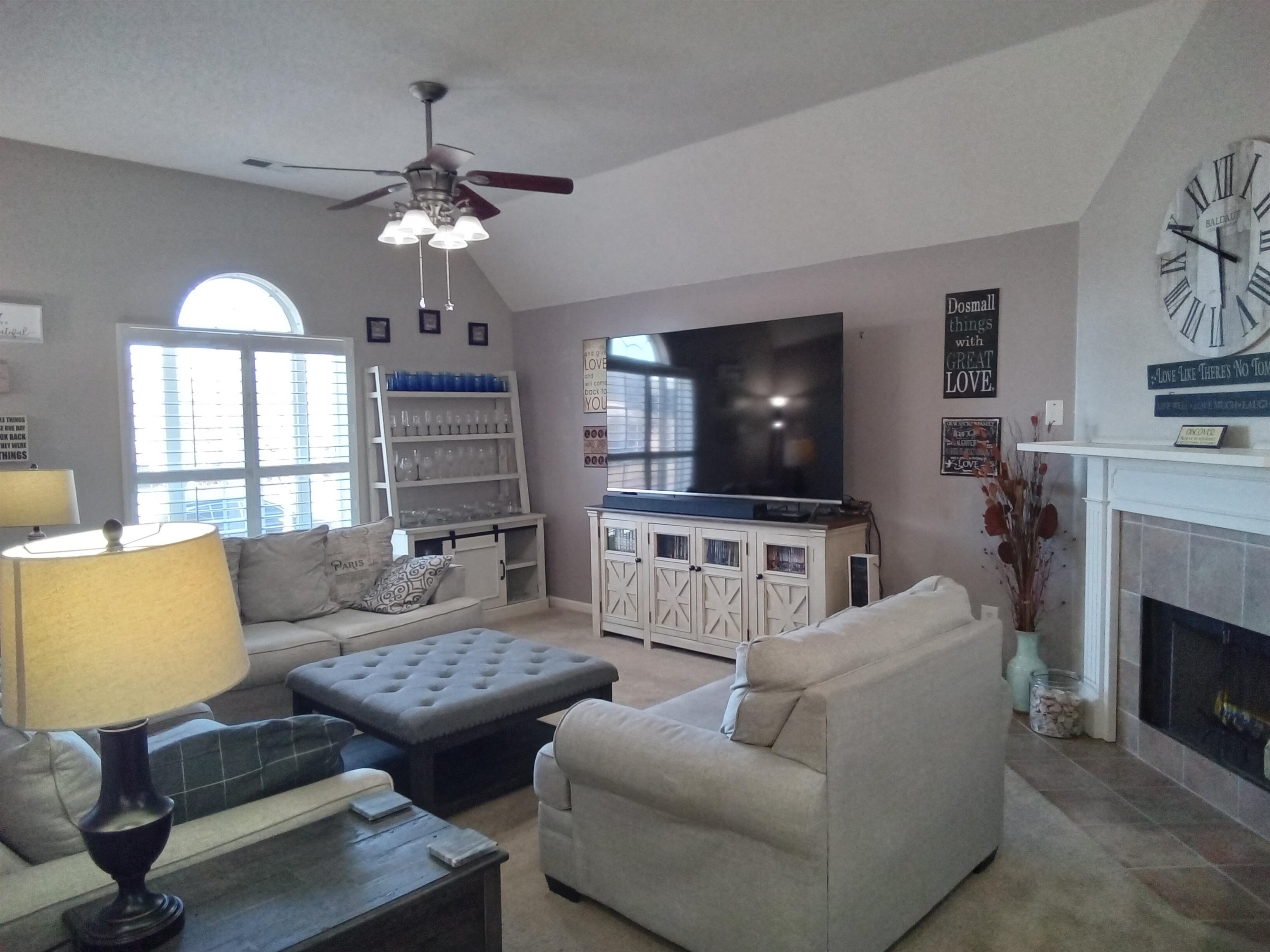 6907 Manslick Road Cordova, TN 38018 - Photo 2 of 24 Living room featuring lofted ceiling, light colored carpet, ceiling fan, and a tile fireplace