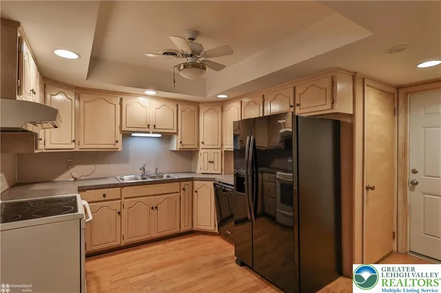 a kitchen with stainless steel appliances a refrigerator sink and microwave