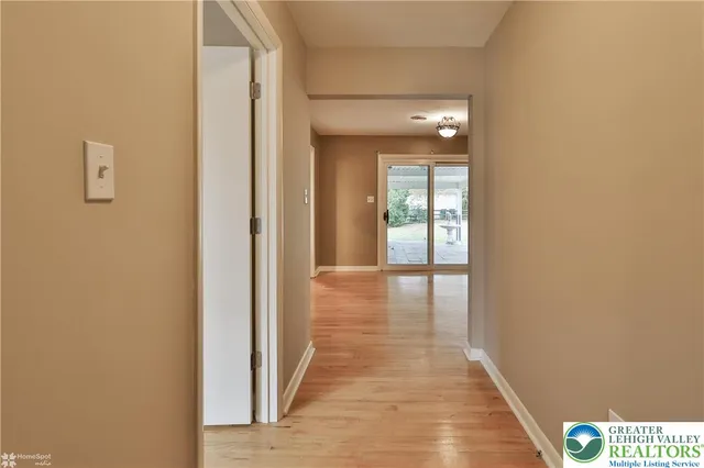 a view of a hallway with wooden floor