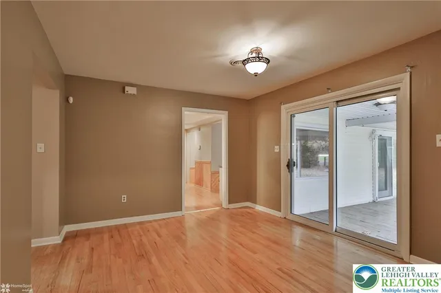 a view of an empty room with glass door