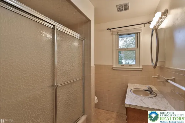a bathroom with a sink and a window
