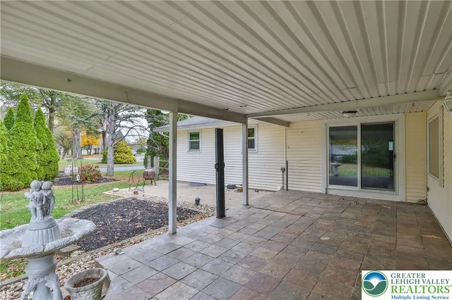 a front view of a house with swimming pool having outdoor seating