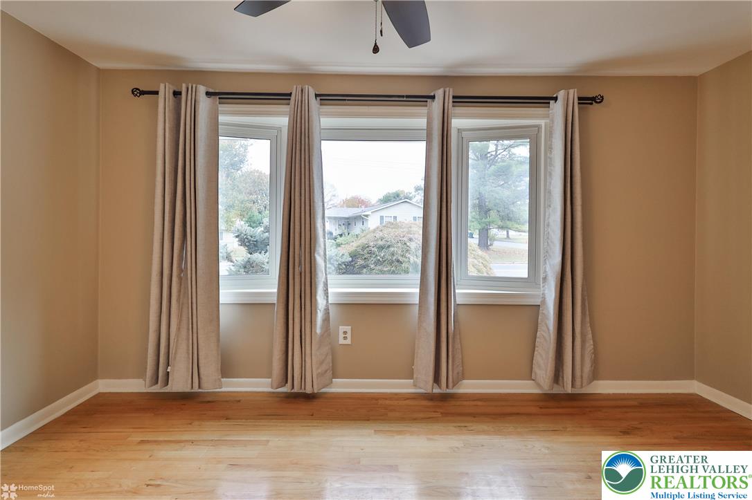 900 Mine Lane Road Easton, PA 18045 - Photo 8 of 51 an empty room with wooden floor and windows
