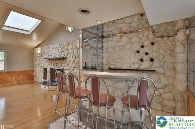a view of a dining room with furniture and a fireplace