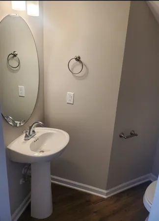 a bathroom with a sink toilet and mirror