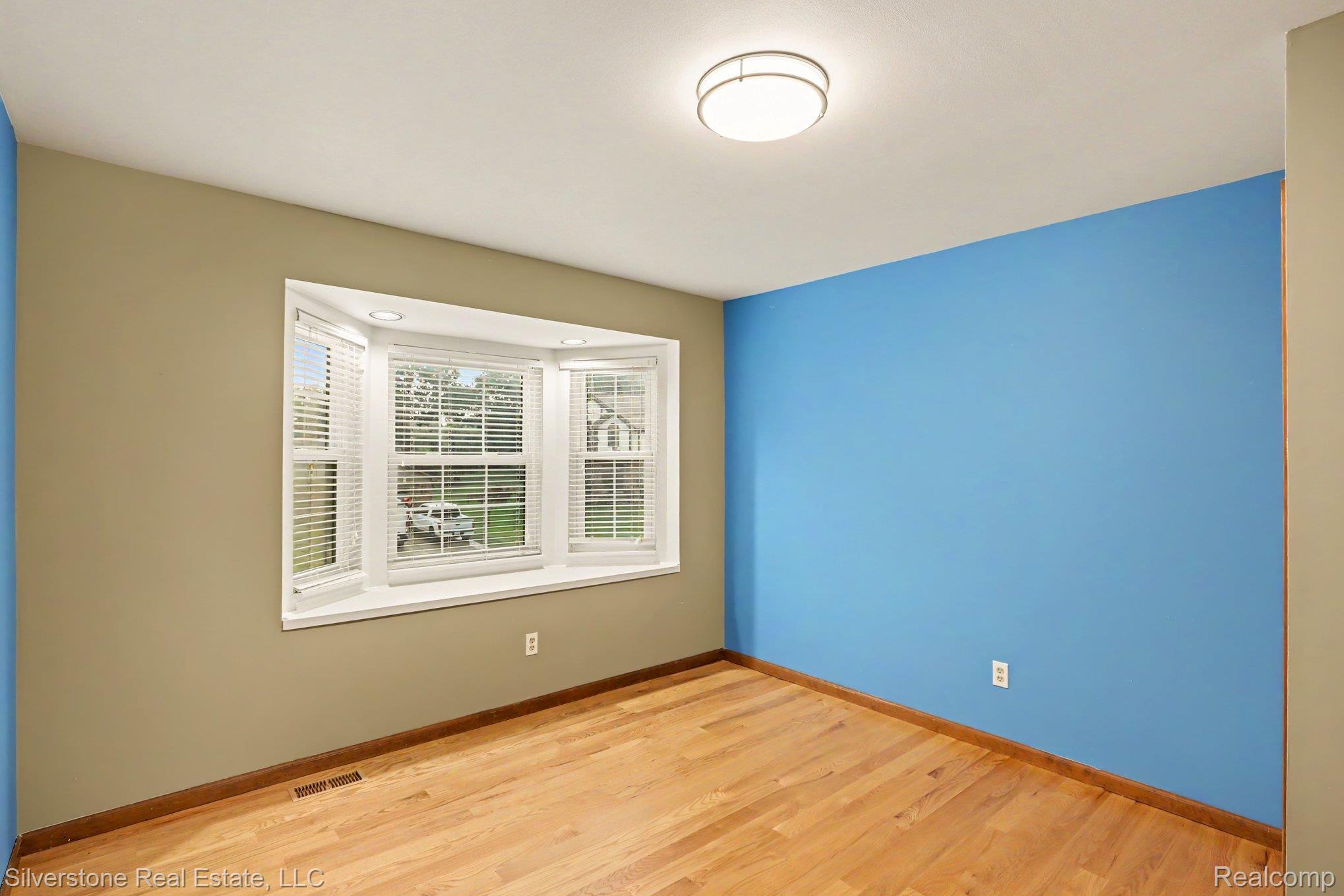 869 Timberline Drive Rochester, MI 48309 - Photo 17 of 29 Hardwood flooring, bay window with integrated seating, recessed lighting, and a flush mount ceiling fixture