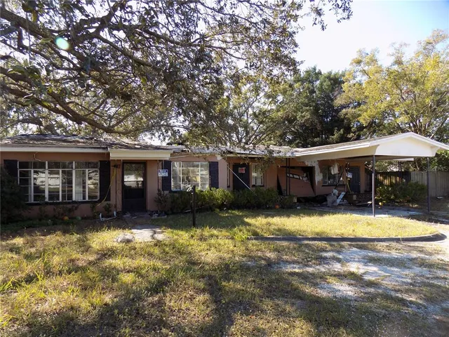a view of house with outdoor space and swimming pool