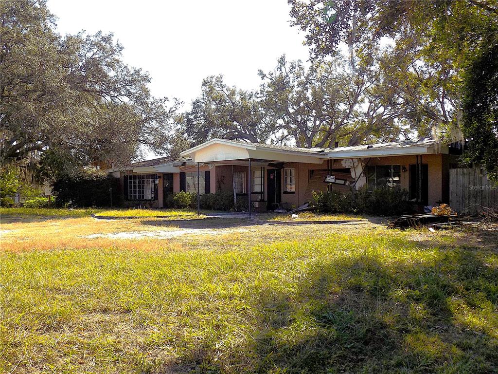 5509 Temple Heights Road Temple Terrace, FL 33617 - Photo 9 of 9 a view of a house with swimming pool and a yard with furniture