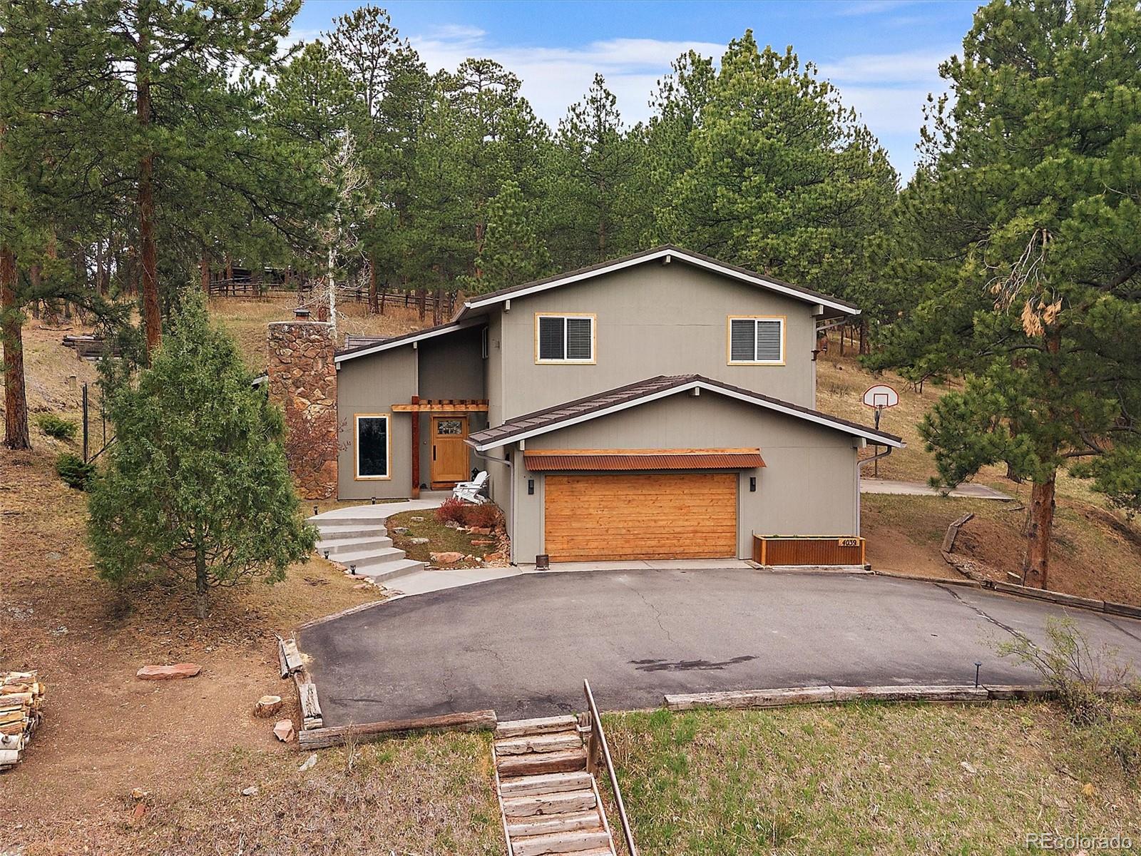 4039 Histead Way Evergreen, CO 80439 - Photo 1 of 48 a front view of a house with a yard