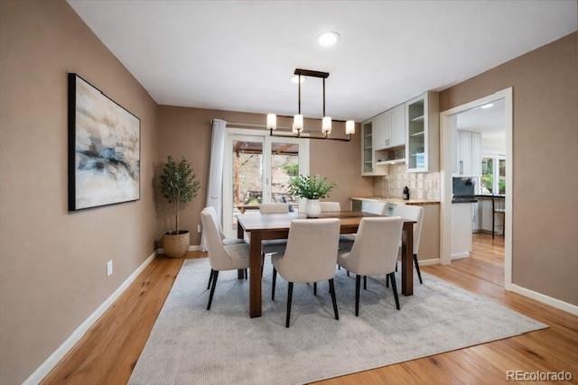 4039 Histead Way Evergreen, CO 80439 - Photo 13 of 48 a dining room with furniture a rug and wooden floor