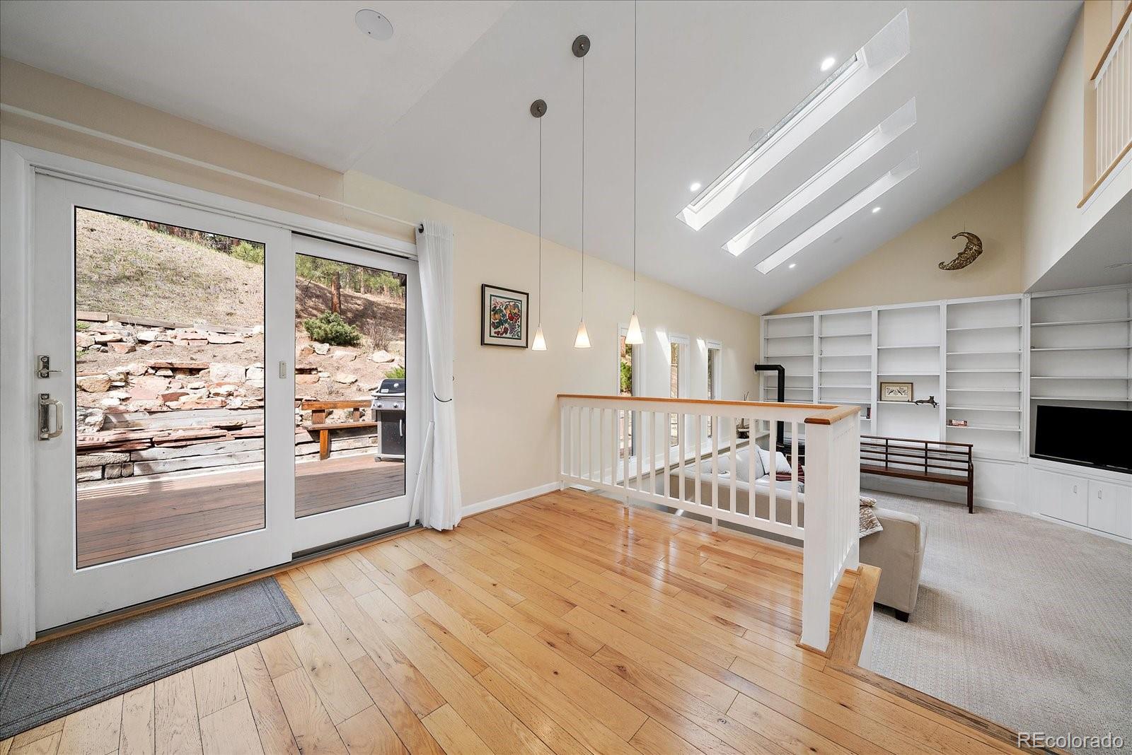 4039 Histead Way Evergreen, CO 80439 - Photo 15 of 48 a view of a living room with wooden floor
