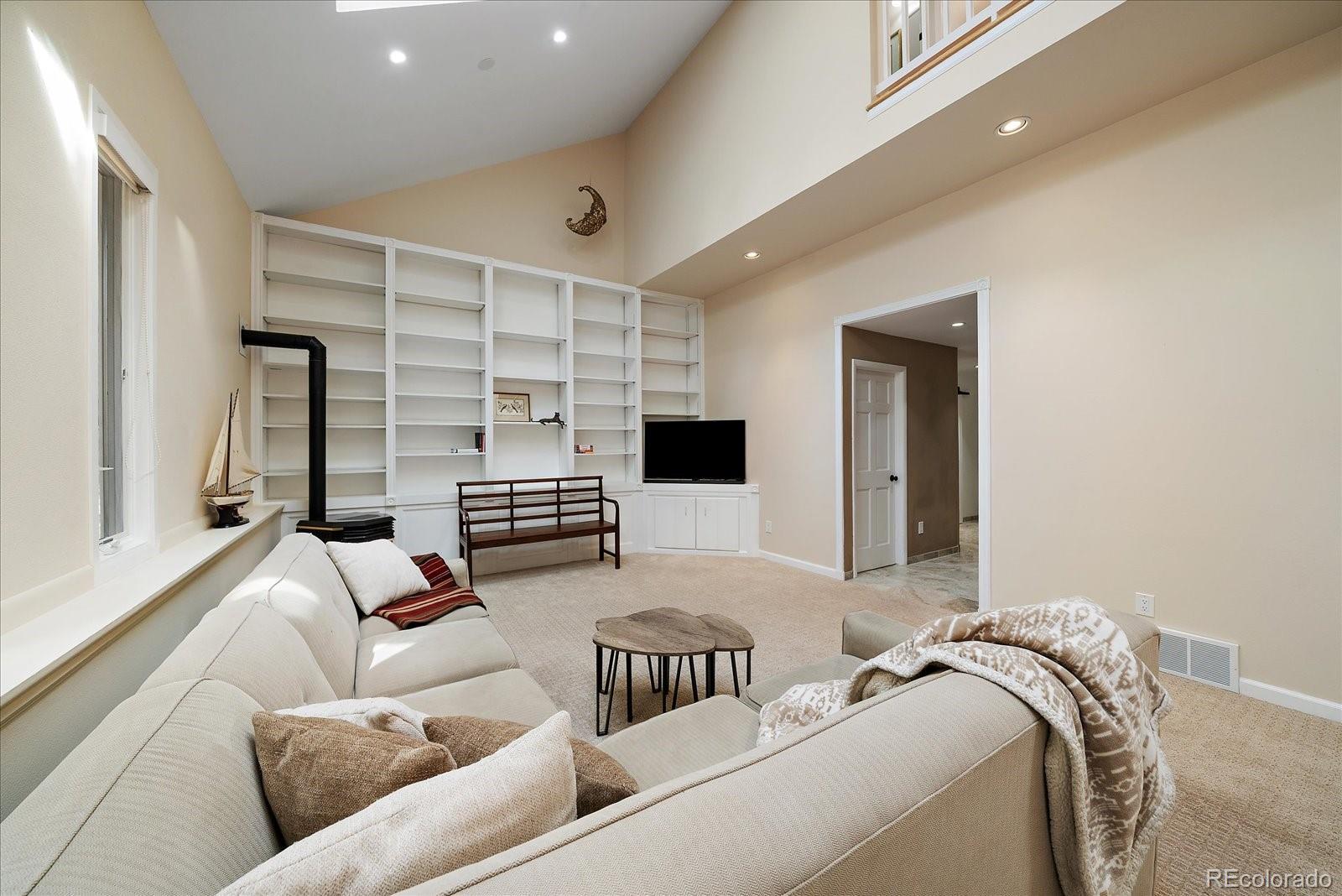 4039 Histead Way Evergreen, CO 80439 - Photo 21 of 48 a living room with furniture and a flat screen tv