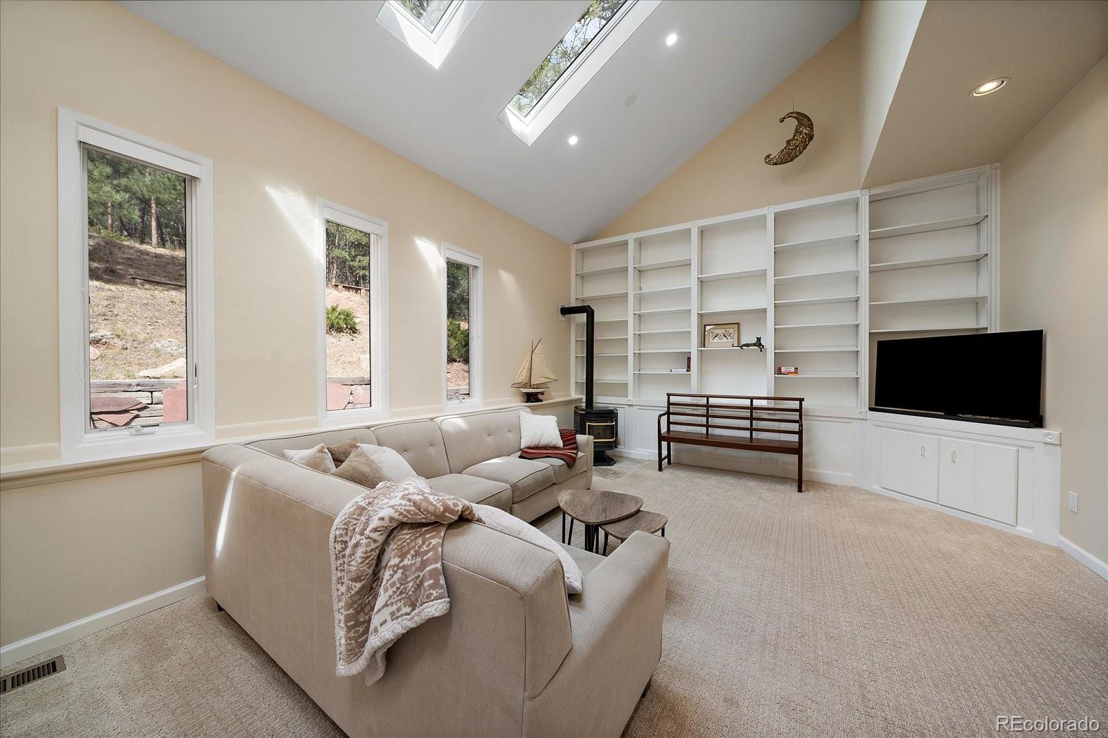 4039 Histead Way Evergreen, CO 80439 - Photo 22 of 48 a living room with furniture and a flat screen tv