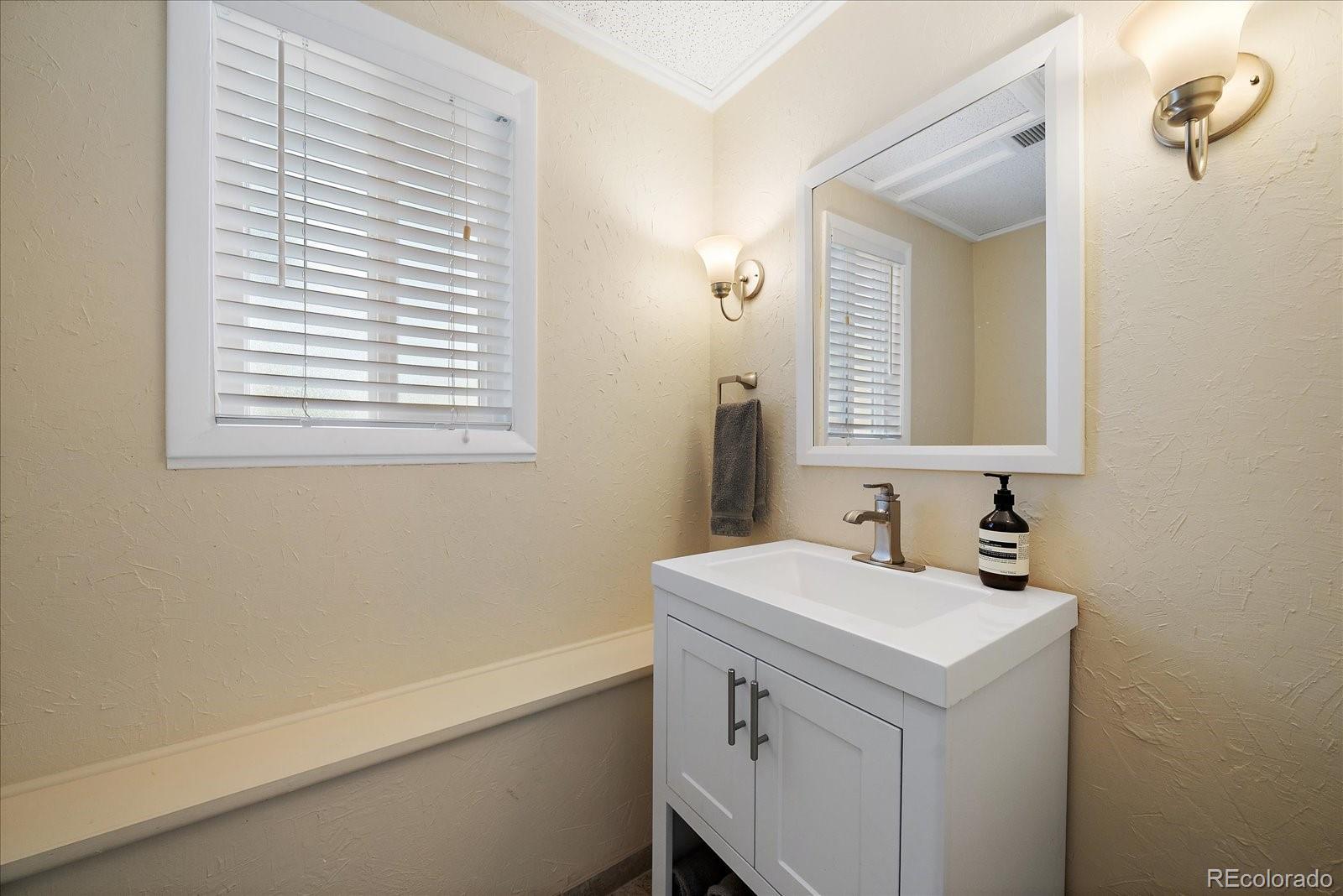 4039 Histead Way Evergreen, CO 80439 - Photo 26 of 48 a bathroom with a sink and a mirror
