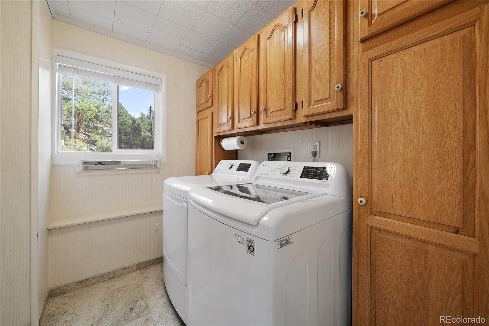 4039 Histead Way Evergreen, CO 80439 - Photo 27 of 48 a utility room with dryer and washer