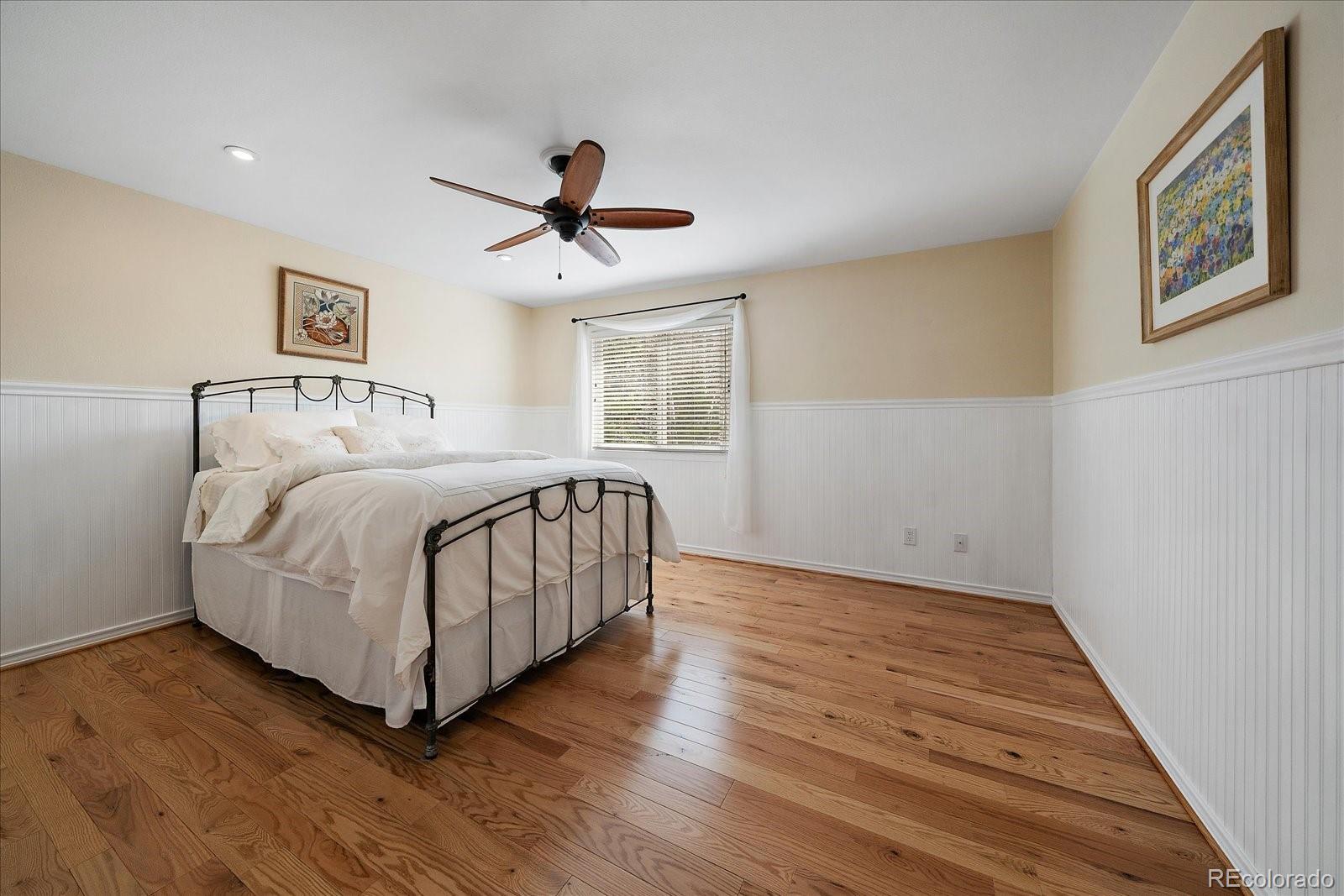 4039 Histead Way Evergreen, CO 80439 - Photo 29 of 48 a bedroom with a large bed a chandelier and closet